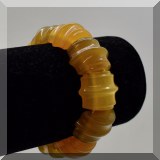 J139. Amber colored Bakelite or other plastic bracelet with ridged beads. -$15